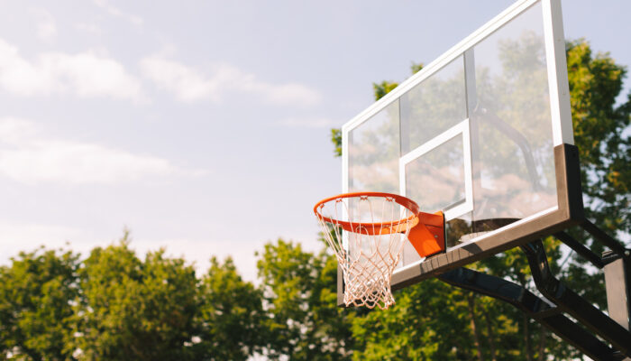 Side angle of a basketball hoop and a cloudy sky